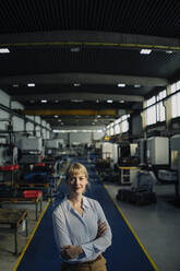 Portrait of a confident businesswoman in a factory - KNSF07792