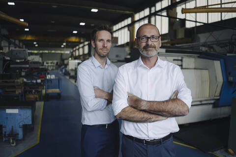 Portrait of two confident men in a factory stock photo