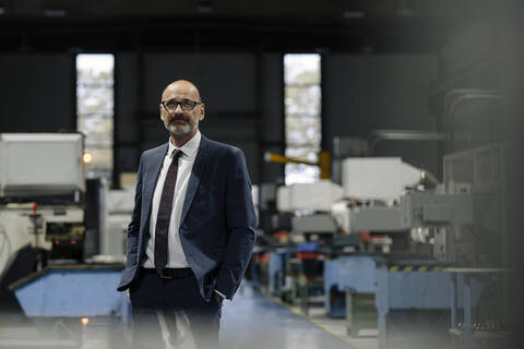 Portrait of a businessman in a factory stock photo