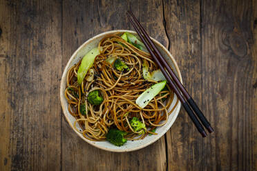 Bowl of Japanese soba noodles with bok choy, broccolies, soy sauce and black sesame - LVF08658