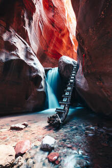 Long Exposure of waterfall flowing down rock steps in narrow canyon - CAVF76190