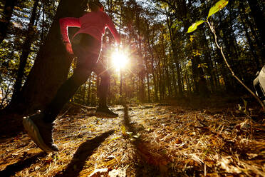 A woman trail running up a hill. - CAVF76231