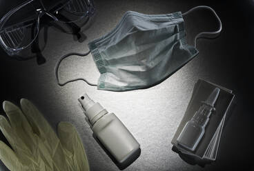 Nasensprays und Desinfektionsmittel, chirurgische Maske, Schutzbrille, Einweghandschuhe und ein Bündel Taschentücher - DIKF00373