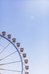 Germany, Bavaria, Munich, Low angle view of Ferris wheel standing against clear sky - MMAF01279