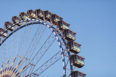 Germany, Bavaria, Munich, Low angle view of Ferris wheel standing against clear sky - MMAF01290