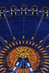 Germany, Bavaria, Munich, Low angle view of Ferris wheel glowing against clear sky at dusk - MMAF01291