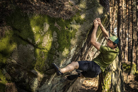 Climber bouldering on rock, Hochberg, Edenkoben, Rhineland-Palatinate, Germany stock photo