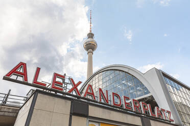 Germany, Berlin, Low angle view of Alexanderplatz train station with Fernsehturm Berlin in background - WPEF02704
