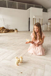 Girls playing with ducks for Easter - CAVF76584