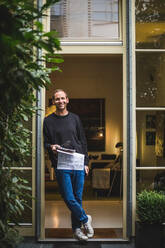 Portrait of male architect standing in house doorway - MASF16846