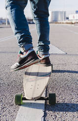 Close-up of anonymous man on longboard - CAVF76675