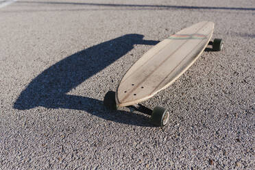 Isolated longboard in the asphalt - CAVF76676