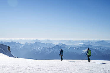 Two female mountaineers make their way across a glacier on Mt. Baker - CAVF76741