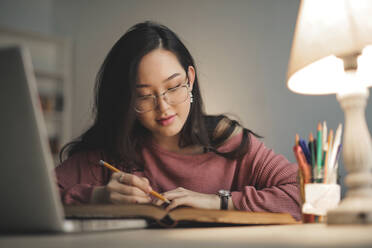 Young asian woman studying at home - CAVF76968