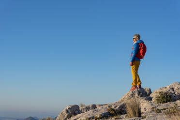 A woman hiking in the high country, El Divino mountain, Costa Blanca - CAVF77030