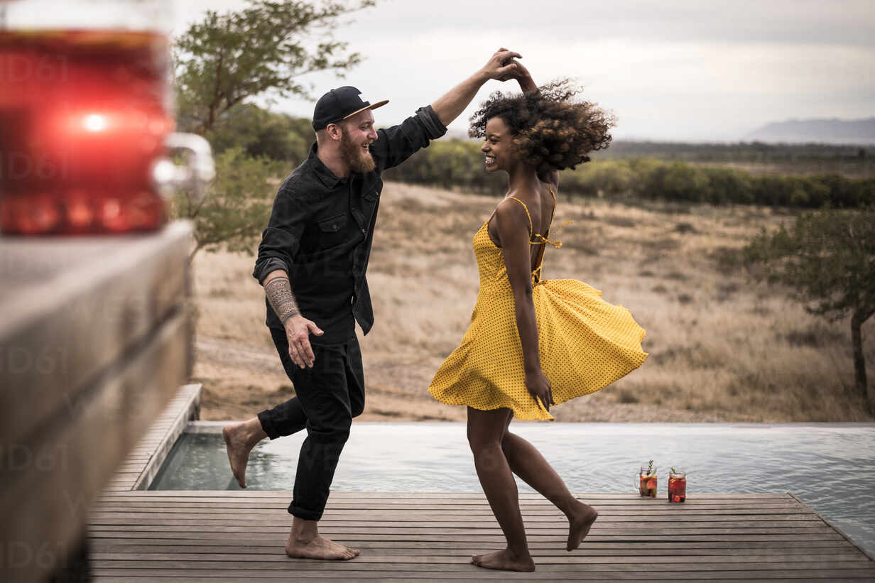 Happy couple dancing on deck of a lodge, Cape Town, South Africa stock photo