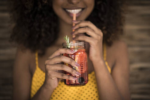 Close-up of woman drinking fresh ice tea drink - MJRF00255