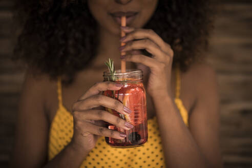 Close-up of woman drinking fresh ice tea drink - MJRF00270