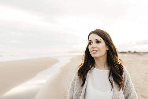 Portrait of a young woman on a remote beach at sunset stock photo