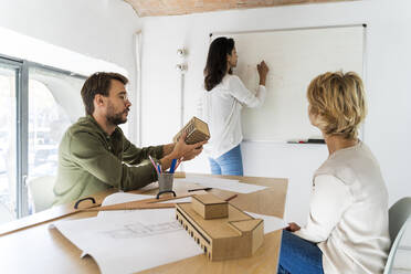 Colleagues having a meeting in architectural office - AFVF05612