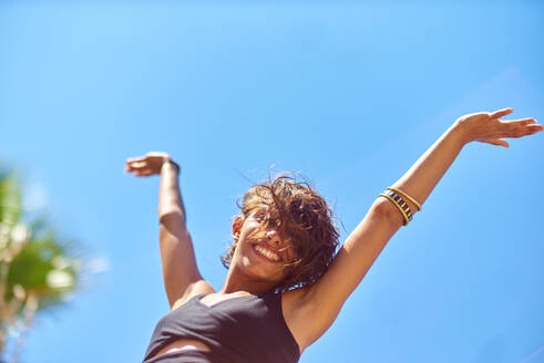 Low Angle View Of Woman Against Clear Blue Sky - EYF00259