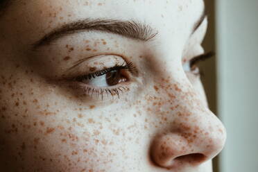 Close-Up Of Thoughtful Woman With Freckles On Face - EYF00305