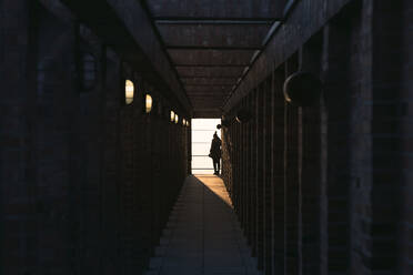 Rear View Of Woman At End Of Corridor - EYF00467