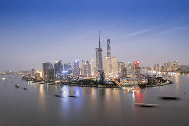 The illuminated skyline of Pudong district in Shanghai with the Huangpu River in the foreground, Shanghai, China, Asia - RHPLF14011