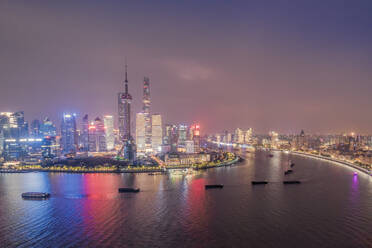 The illuminated skyline of Pudong district in Shanghai with the Huangpu River in the foreground, Shanghai, China, Asia - RHPLF14014