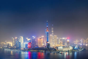 The illuminated skyline of Pudong district in Shanghai with the Huangpu River in the foreground, Shanghai, China, Asia - RHPLF14015