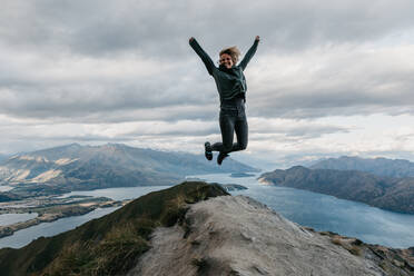 Full Length Of Woman Jumping On Cliff - EYF00725