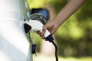 Cropped Hand Charging Car At Station - EYF00873