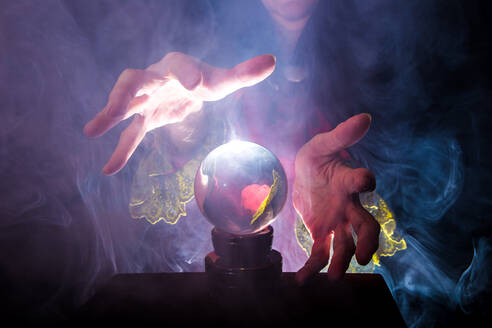 Midsection of Female Fortune Teller By Crystal Ball - EYF00926