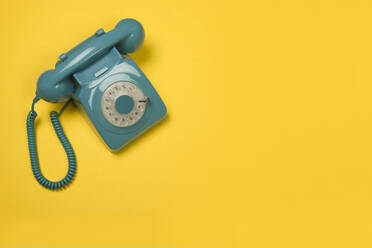 High Angle View Of Telephone On Yellow Background - EYF01035