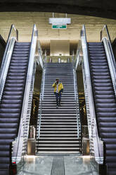 Man walking down stairs in subway station - LJF01402