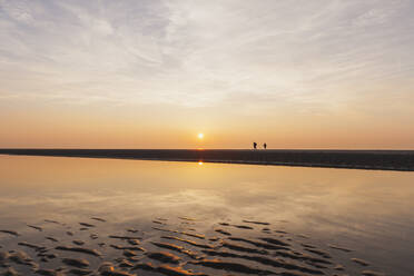 Entfernte Ansicht von Silhouette Menschen am Strand gegen den Himmel während des Sonnenuntergangs, Nordseeküste, Flandern, Belgien - GWF06552