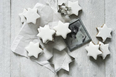 Star shaped cinnamon cookies, cookie cutter and old photograph - ASF06598