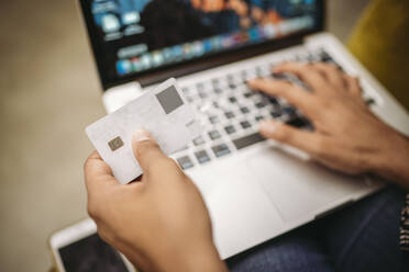 Close-up of woman using laptop and credit card - JPIF00460