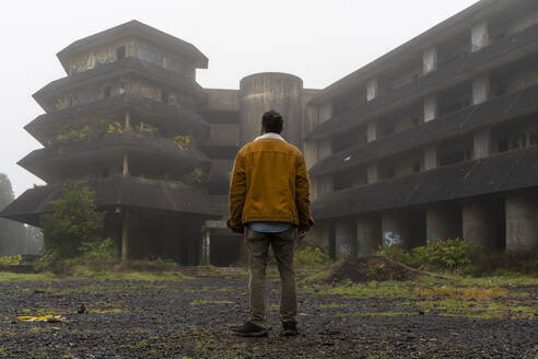 Rear view of man standing at abandonded building, Sao Miguel Island, Azores, Portugal - AFVF05668