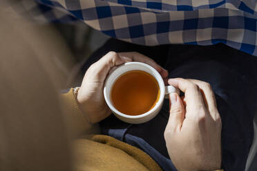 Person drinking tea, elevated view - AFVF05758