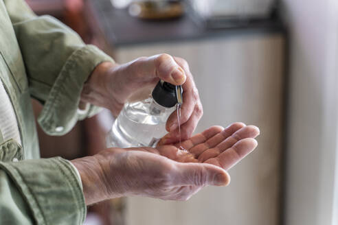 Hands of man, using hand sanitizer - AFVF05765