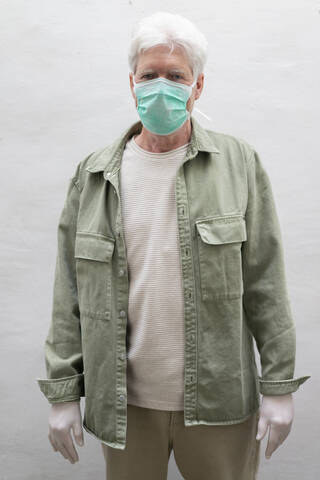 Senior man wearing face mask and protective mask stock photo