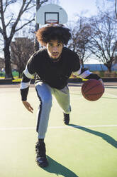 Portrait of basketball player in action on court - MEUF00067