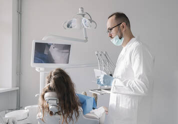 Young woman getting dental treatment in clinic - AHSF02017