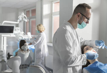 Young woman getting dental treatment in clinic - AHSF02018