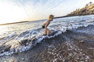 Boy playing at the seafront, Adeje, Tenerife, Canarian Islands, Spain - IHF00266