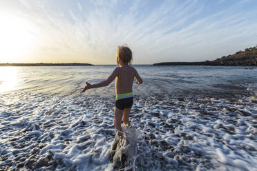 Boy playing at the seafront, Adeje, Tenerife, Canarian Islands, Spain - IHF00267