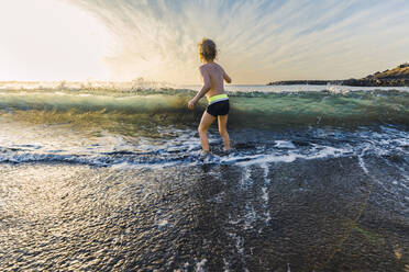 Boy playing at the seafront, Adeje, Tenerife, Canarian Islands, Spain - IHF00268