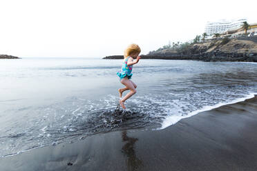 Boy playing at the seafront, Adeje, Tenerife, Canarian Islands, Spain - IHF00278