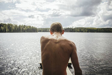 Rear View Of Shirtless Boy Standing By Lake - EYF01052